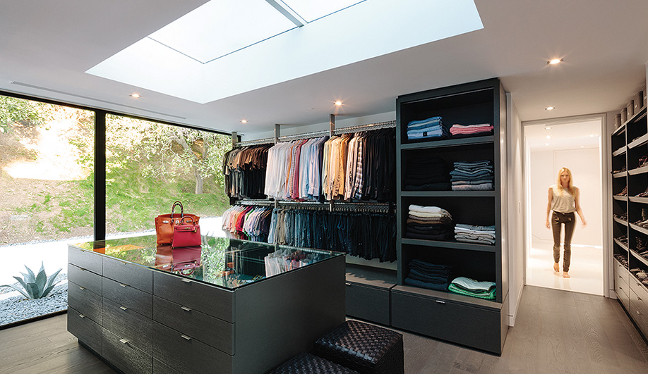 A room-sized wardrobe overlooking the garden features rift-cut white oak shelving and drawers.