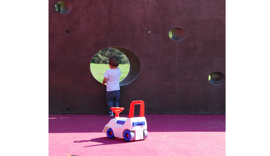 Nursery school design, elevated: the outdoor perimeter wall, with circular openings to peer through