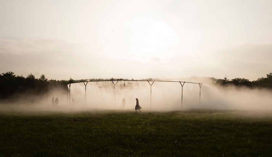 An image of exhibit visitors walking through Fog assembly, an installation from Eliasson's Versailles