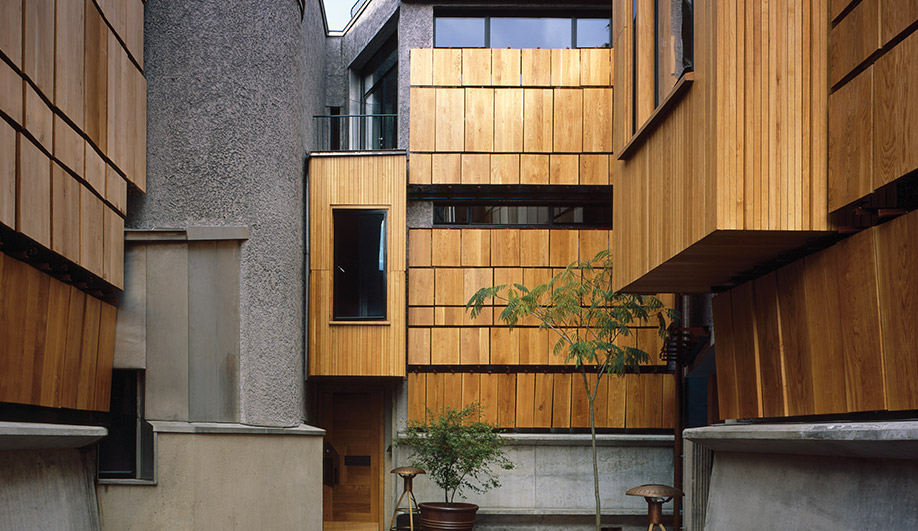 The north side of the courtyard, with shutters closed. A neat cluster of surfaces, volumes and materials – each vying for space – sits in tight quarters.