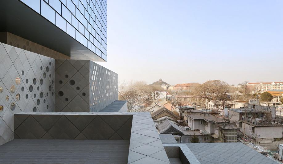 The Guardian Art Center echoes nearby hutongs.