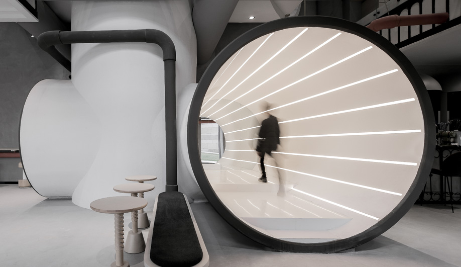 An illuminated tube walkway at Ideas Lab Shanghai by X+Living